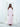 The Vesper Dress in light pink, a silk georgette maxi dress with braided straps and open shoulders.