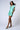 Model wearing Nicilian’s Aura Blouse and San Diego Shorts in Opal — a matching silk set made from regenerative silk twill, featuring a front-pleated top and adjustable tie-waist shorts.