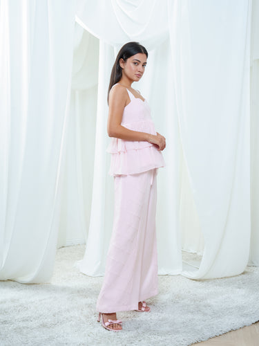 Side view of the Cascade Blouse in light pink, showing the georgette tiers falling from the underbust seam.