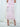 Back view of the Cascade Skirt in light pink, running smooth from the top edge to the ruffled hem.