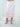 The Cascade Skirt in light pink, a straight silk midi skirt with tiered georgette ruffles at the hem.