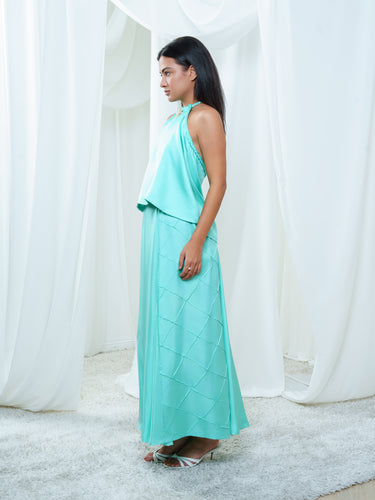 Side view of the Dusk Halter and Dusk skirt in turquoise, open across the back above the Dusk Skirt.
