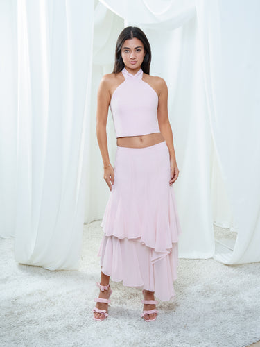 The Float Skirt and Solana Halter in light pink worn as a set, a cropped halter above a tiered silk skirt.