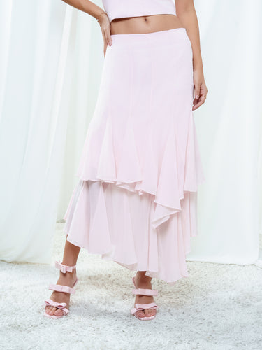 The Float Skirt in light pink, a tiered silk skirt with asymmetric georgette layers and a handkerchief hem.