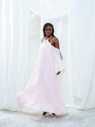 Movement view of the Vesper Dress in light pink, showing the georgette sleeve falling free of the open shoulder.